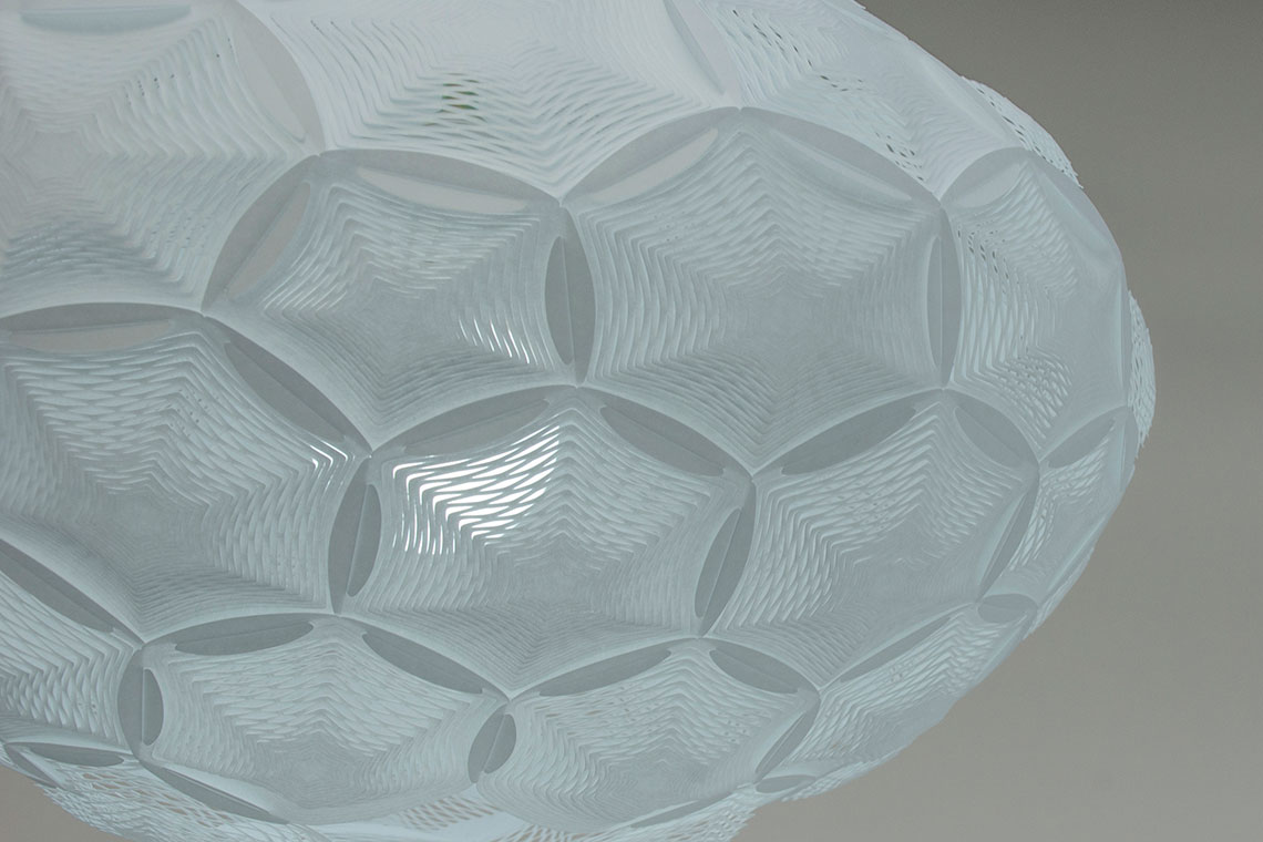 Airy Medium Pendant Lampshade zoom-in detail of perforated rice paper hexagon and pentagon interconnected panels designed by 24d-studio