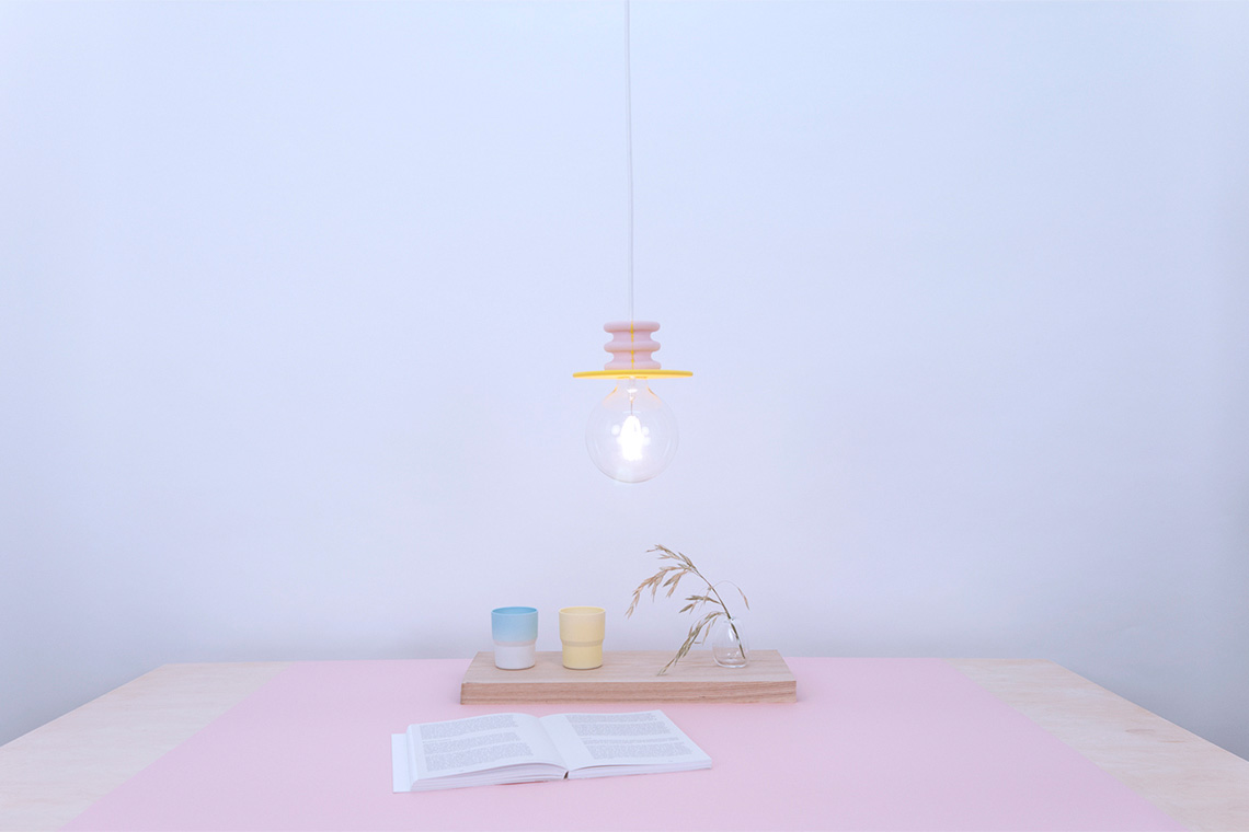 Frutti bright pendant light with pink and yellow stone base with large LED E26 bulb.