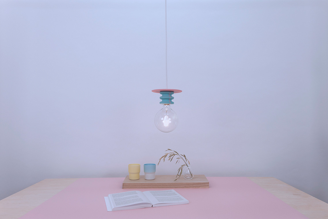 Cyon and pink Frutti ceiling lamp over a dining table setting