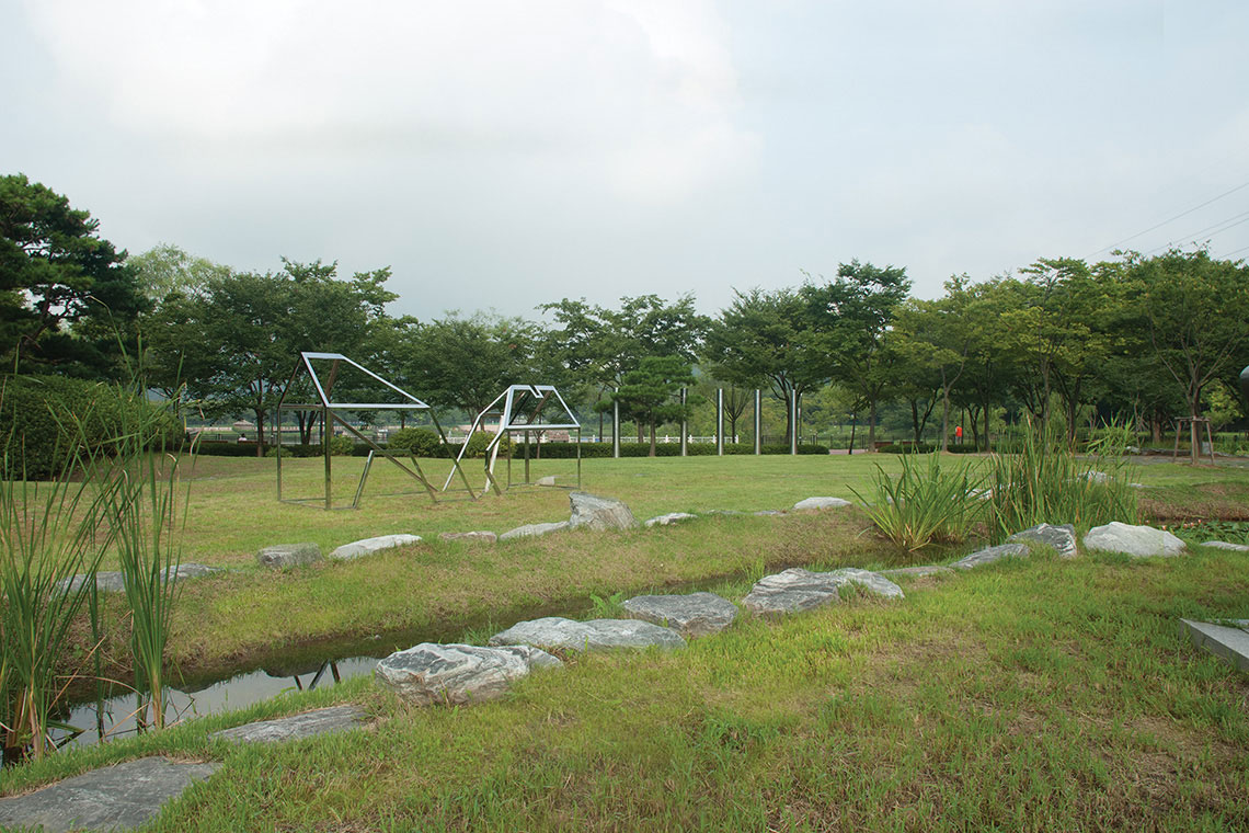 Home stainless steel frame sculpture blurs with natural surroundings