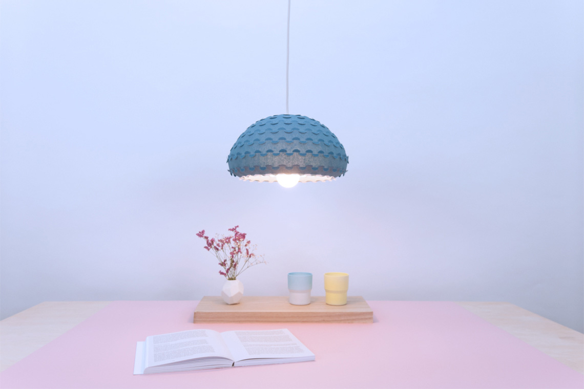 Kasa small midnight blue pendant lamp over a dining table interior view