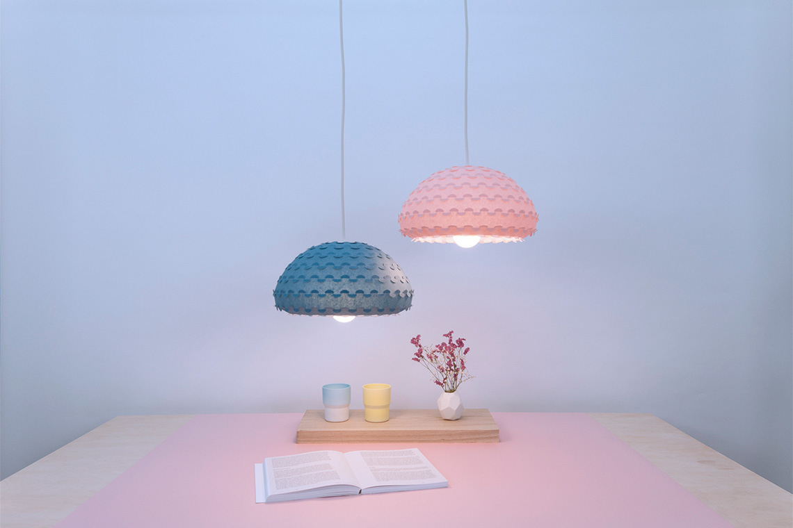 Kasa lamp is a series of bright sculptural pendant lamps with luminous organic form, shown in pink and blue colors.