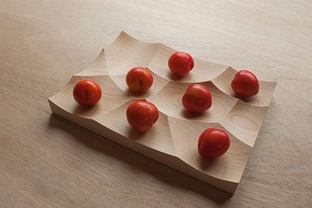 Storm is a versatile milled wood tray inspired by gentle undulating landscapes of the ocean 