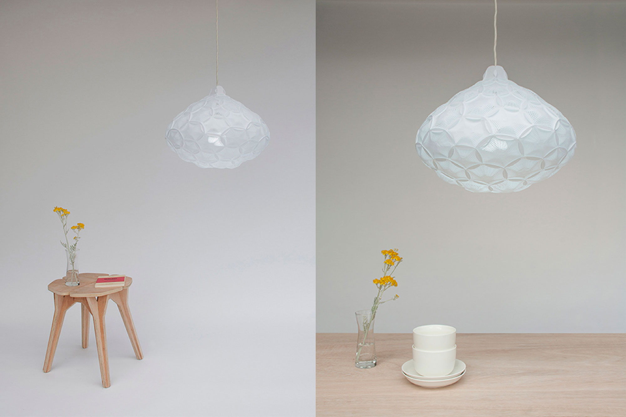 Airy Medium Pendant white lampshade hanging over a wood dining table and Medium Airy lamp hanging over a plywood table with a yellow flower in a vase