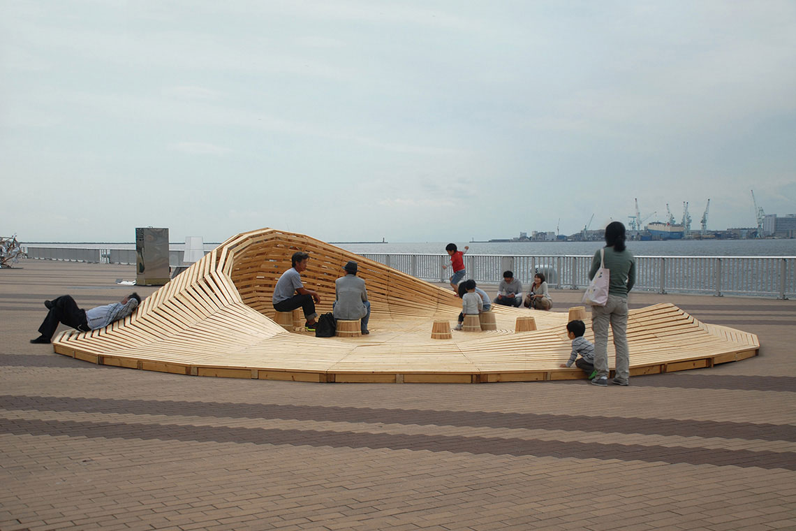 Crater Lake Installation photo showing multiple visitors seating and laying down inside the landscape platform.