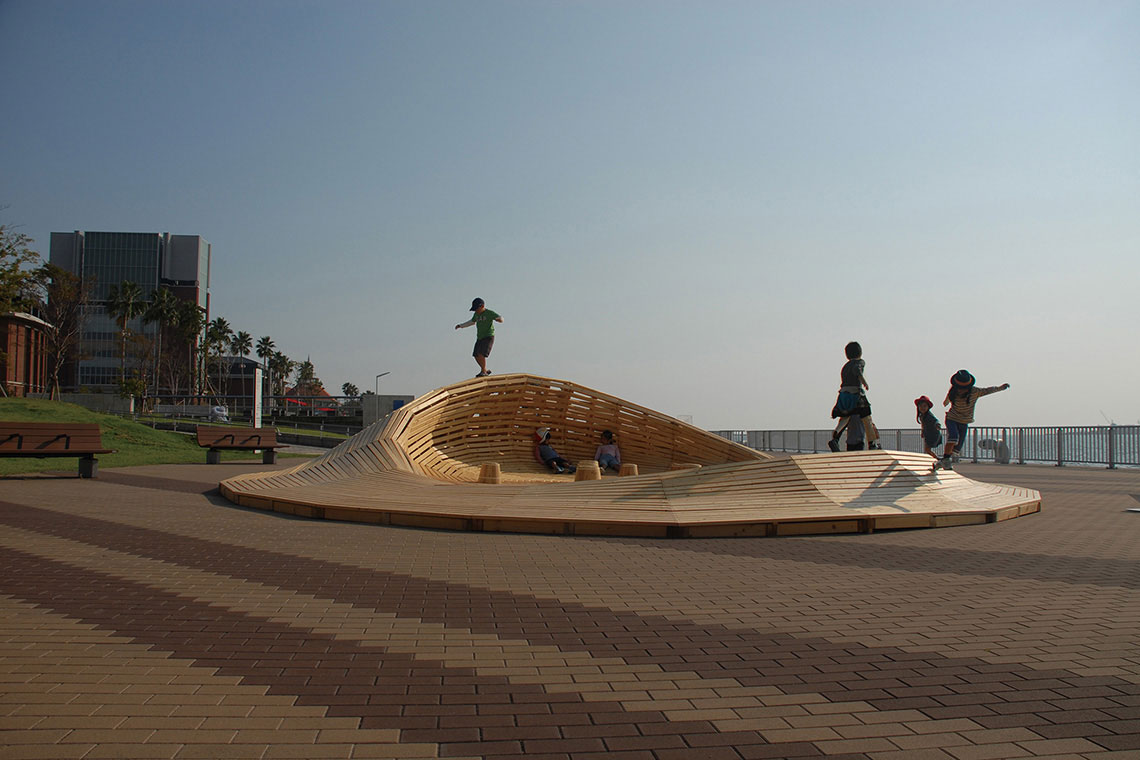 Crater Lake installation wood mountain scape is occupied by running and climbing children.