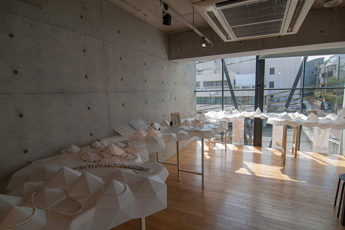 Off-white origami folded top surface created a neutral background for various jewelry display.